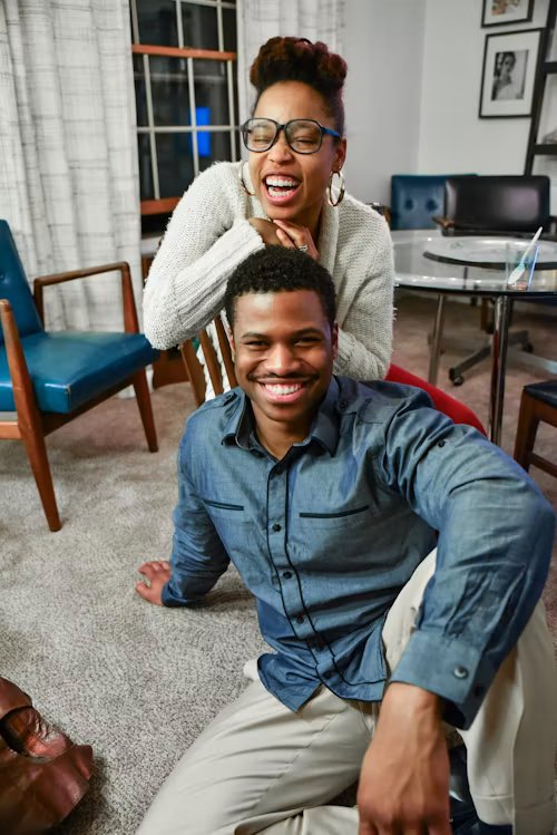 A couple laughing together at home